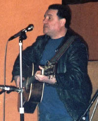 Mike Dillon playing guitar and singing